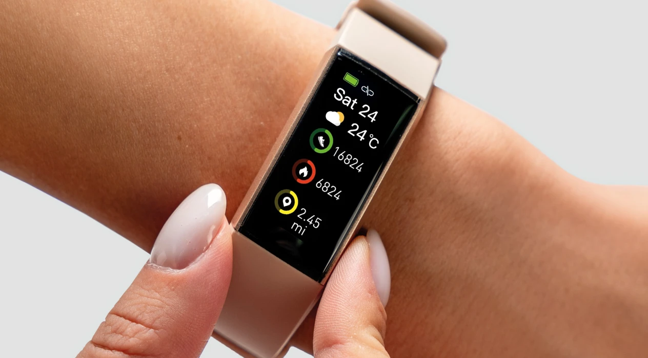 A smartwatch displays fitness metrics like steps and heart rate on the screen. A person is adjusting it on their wrist in a neutral, gray-background setting.