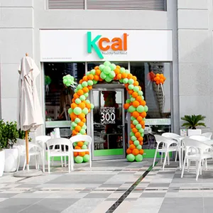 Kcal Healthy Food Restaurant Opening in Business Bay in 2011 with green and orange balloons decorating the entrance.