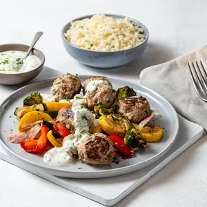 Kcal's Greek Meatballs with roasted seasonal veg and tangy tzatziki sauce.