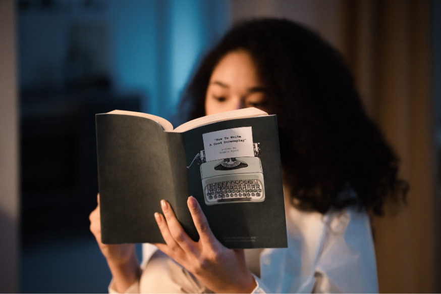 Woman reading a book in the evening