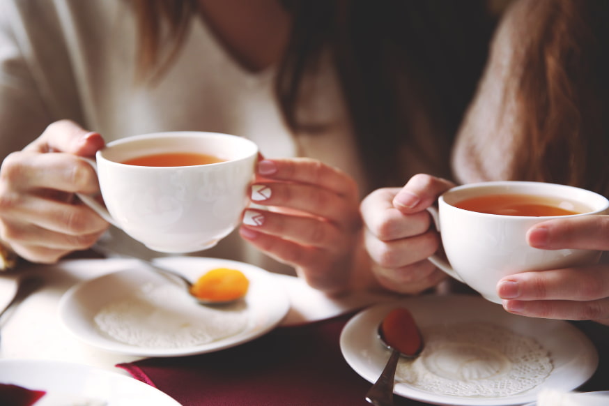 Two friends sharing a cup of tea