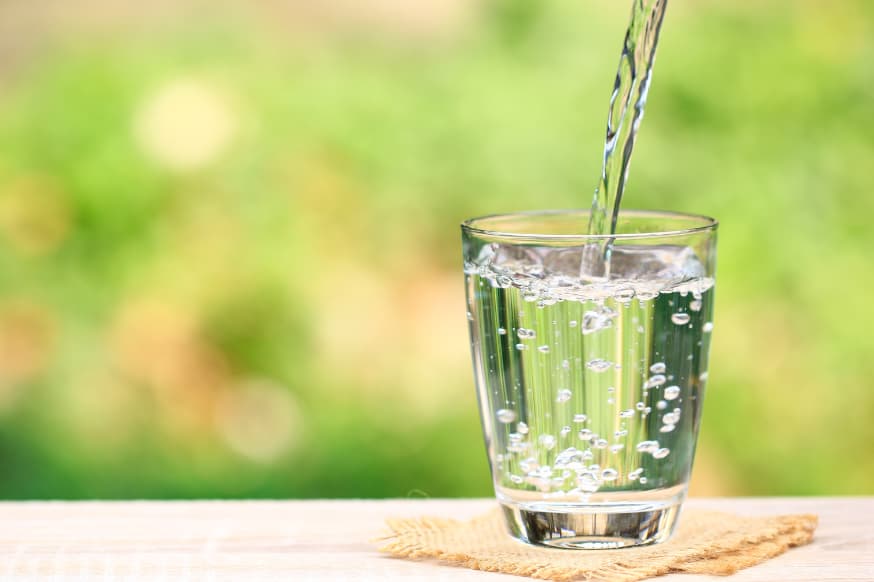 glass of cold water on a table outside