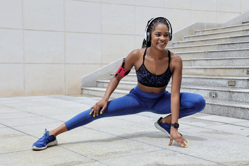 Fit woman improving her mobility through stretching and movement