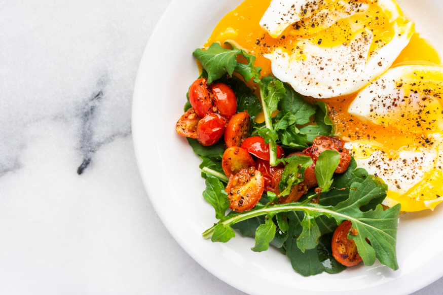 Poached eggs with rocket and tomato salad for a protein breakfast