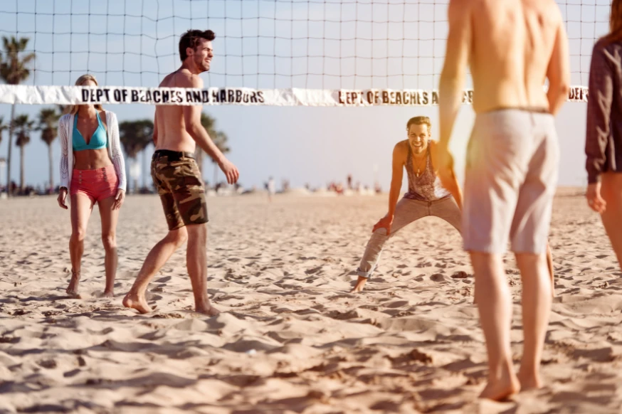 People playing beach volleyball as their hobby