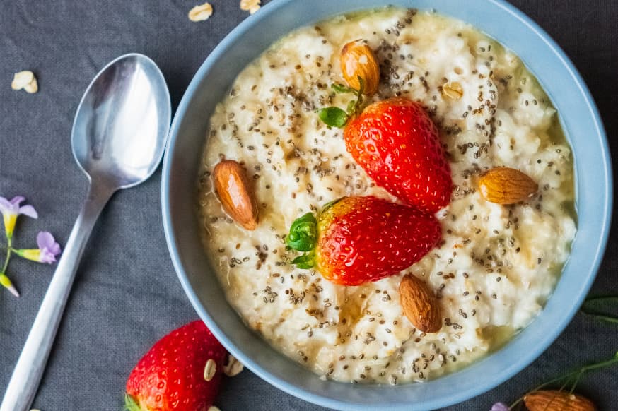 Bowl of oats topped with fresh strawberries