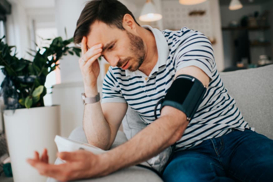 Arab man checking his blood pressure while fasting