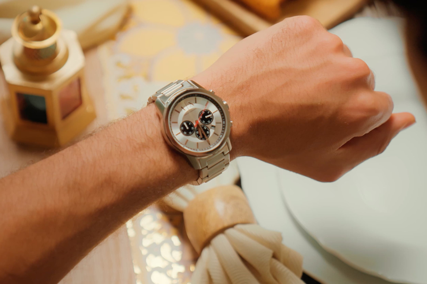 man looking at his watch  waiting to break his fast during ramadan