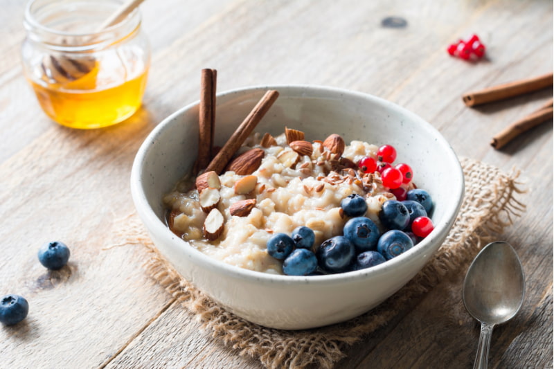 Bowl of oatmeal porridge with added fruit and nuts