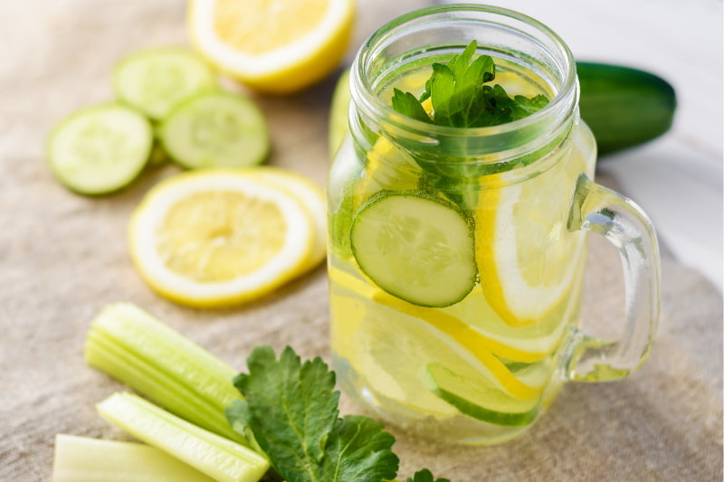 Glass of water flavoured with lemon and cucumber