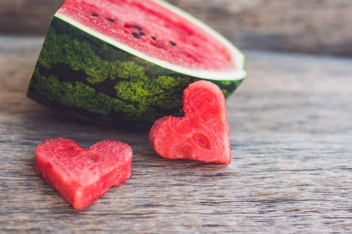 Quarter of a watermelon with two slices shaped like hearts